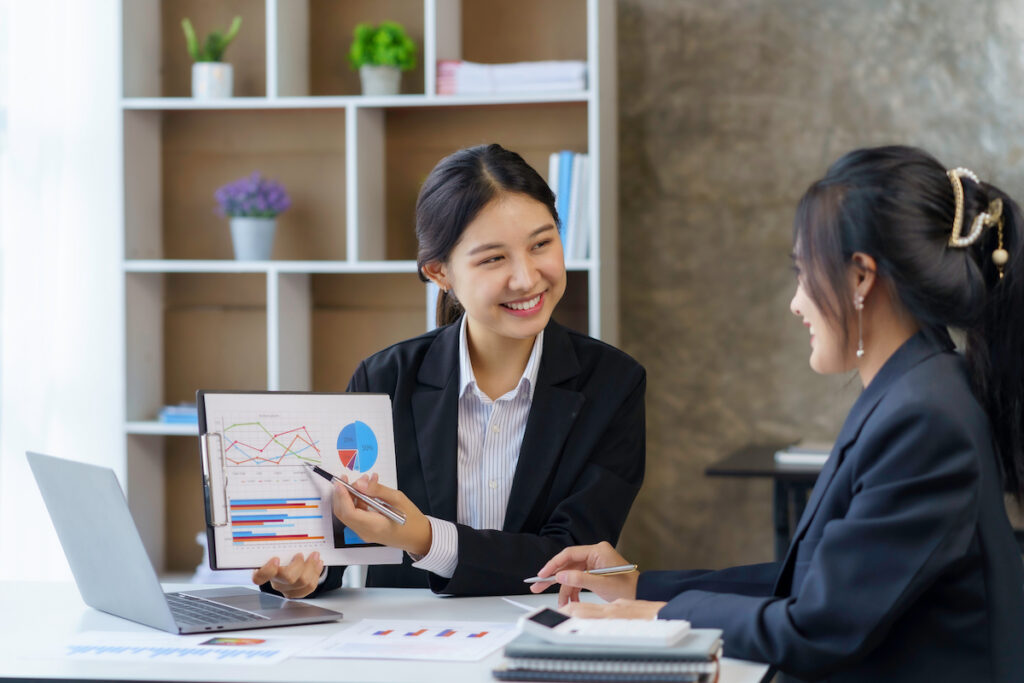Two young professionals engaged in a business presentation