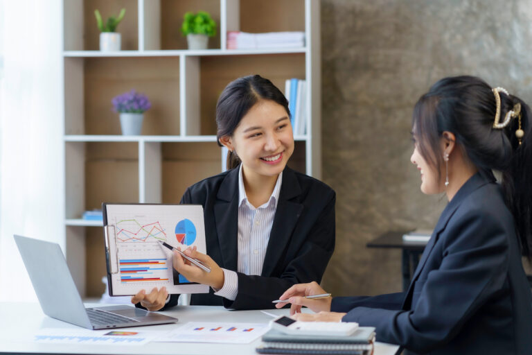 Two young professionals engaged in a business presentation